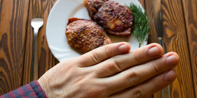 a man refusing a delicious steak