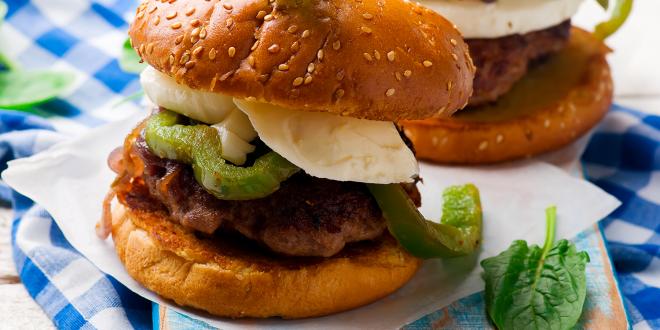 A plate of chicken sausage sliders with bell peppers and fresh basil