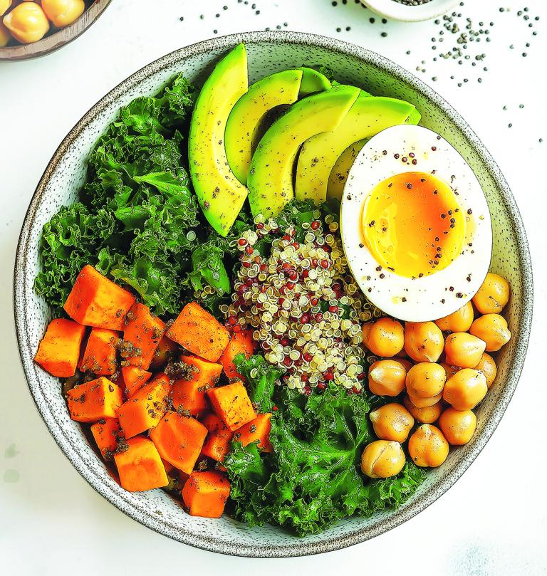 Kale, quinoa, chickpea and sweet potato salad in a bowl.